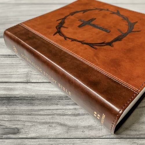 Leather-bound journaling study Bible on wooden surface
