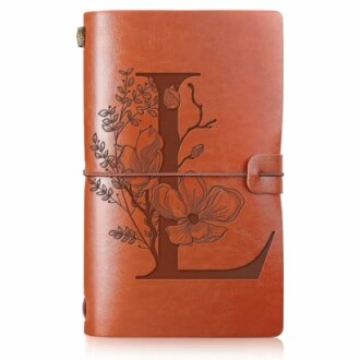 Leather journal with embossed letter L and floral design.