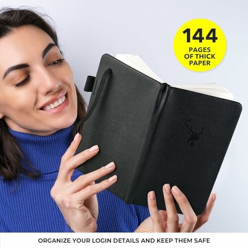 Woman holding a black notebook with 144 pages of thick paper.